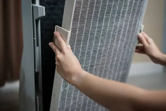 operator replacing pleated secondary hepa filter layer for clean workshop indoor air return system